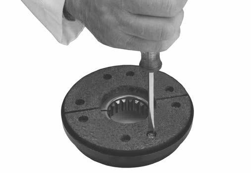 11. Remove the screws which retain the friction disc segments.