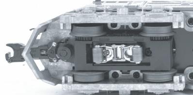 2. Once the cab is removed, remove the trucks by unscrewing the black Phillips motor mount screw located on the underside of the drive trucks (see above). 3.