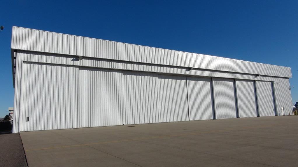 HANGAR AMENITY DESCRIPTION Hangar Door: The hangar door is a 8-section bi-parting bi-directional bottom rolling door. The door panels are controlled from inside the hangar.