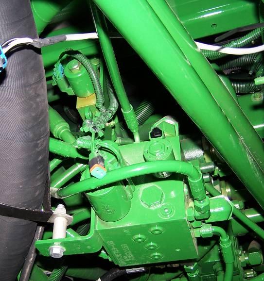 Figure 22: John Deere valve block with electrical connectors 6. Route the long cable (with Deutsch connectors) on C21 under the sprayer.