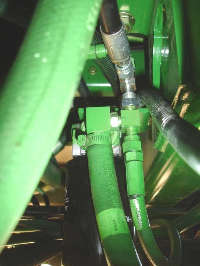 Tee hose H70 into the port on the priority valve labeled EF. This is located on the left hand side, under the rear corner of the cab outside the frame.