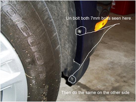 4. Next you will remove both 7mm bolts in each of the wheel wells, as shown in the picture below.