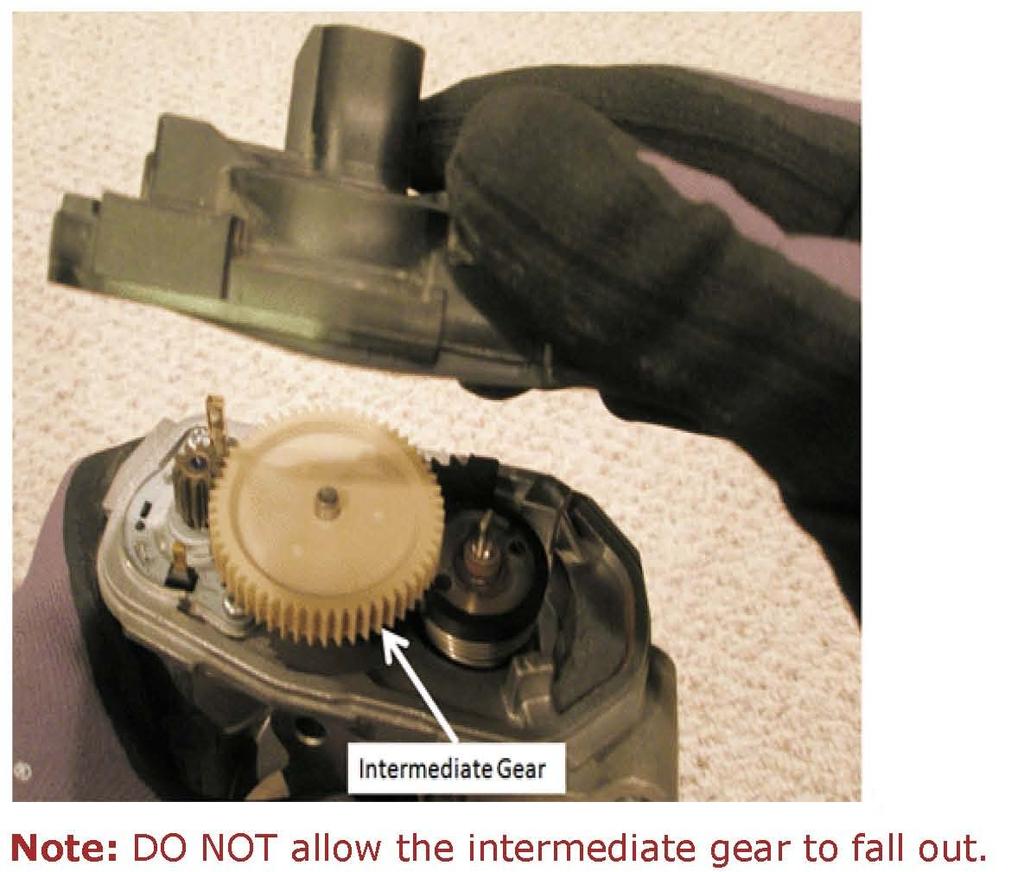 11. Hold the throttle body with your hand, so that the TP sensor cover is facing upward. Grasp the TP sensor cover and carefully lift it up and separate it from the throttle body. 12.