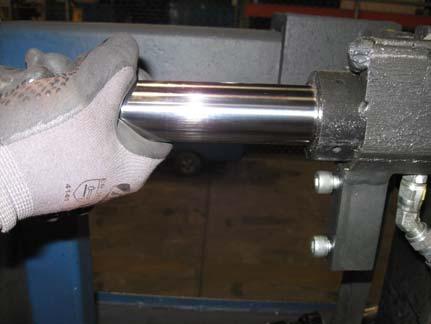 Loosen both the left and right hydraulic fittings (1/2 to 1 full turn) to relieve the