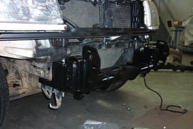 Install two M14 x 60mm bolts and washers through factory tie down eye into underside of left hand chassis rail.