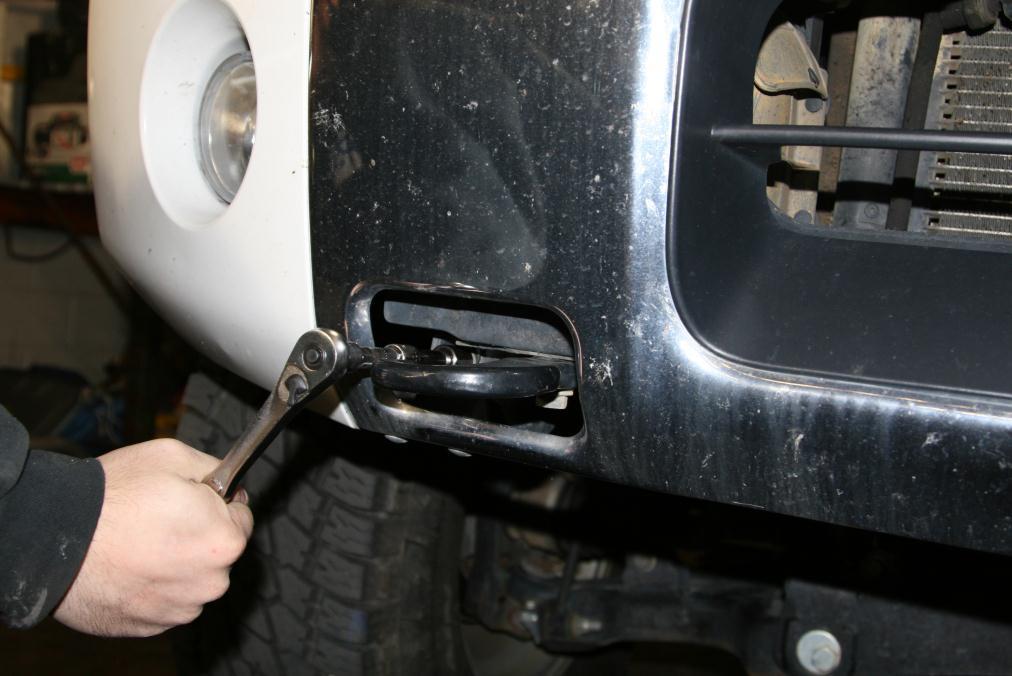 E. Using a 17mm socket remove the two bolts holding the