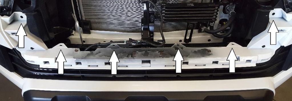 Once the inner fender is pulled back, you can get to the 4 clips that hold the end of the fender flair, and the 1 clip holding the bumper skin that needs to be released that is in the middle of