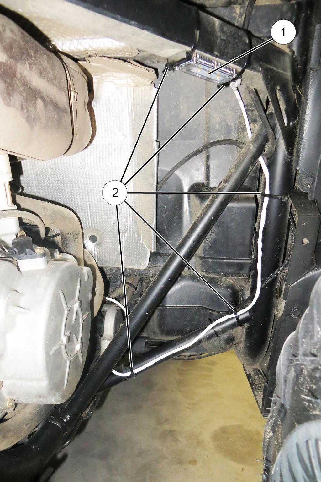 Route light harness down and inboard to vehicle centerline as previously shown, then follow main vehicle harness forward through center console. c. Exit center console near accent light electrical d.