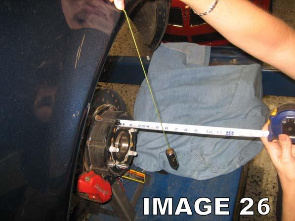 Duplicate steps 49-50 for the passenger side Watts link arm. 51. As shown in Image 26, use a plumb bob to determine proper axle location.