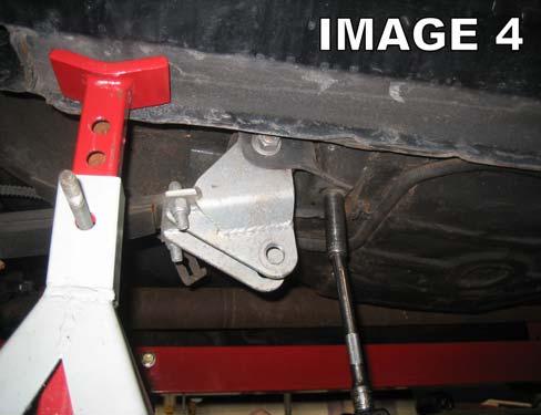 Using a 5/8 socket, loosen and remove the rear leaf spring shackle bolts. Loosen the upper shackle bolt at the frame and remove the shackles. (Image 3) 14.