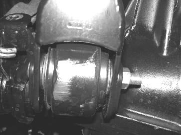 Using the supplied ¾ x 4 ½ bolt, nut, and washers attach the bearing end of the link arm with the misalignments to the lower hole in the new frame bracket.
