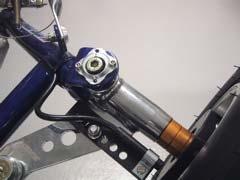 The cable is fixed to the frame in a nice large curve so the wheel can turn without the cable being caught or tightened.