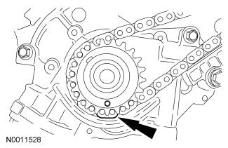 the crankshaft sprocket with the single copper (marked) link on the chain. 13. NOTE: Make sure the upper half of the timing chain is below the tensioner arm dowel.