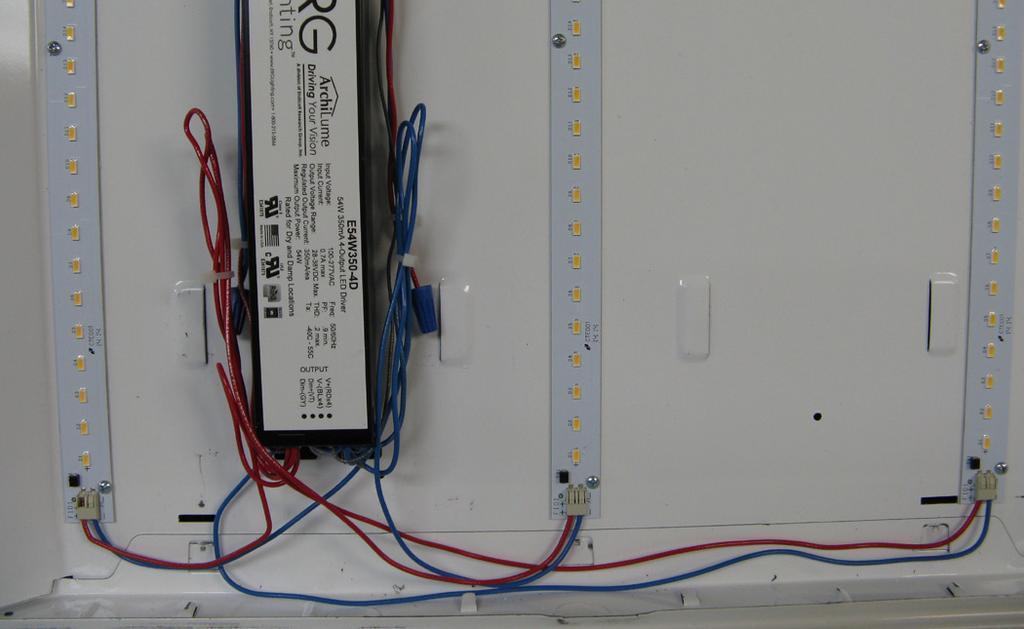 In 2 x2 fixture, the driver and wires may sit underneath a ballast cover (standard) or a cover plate.