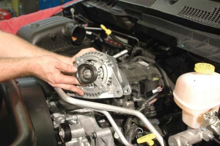 29. Use a 15mm wrench to remove the two alternator mounting bolts. 30.