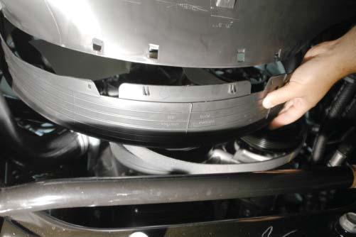 65. Pull the lower fan shroud away from the vehicle by unsnapping the clips and pulling down