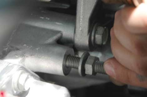 105. Remove the center upper water pump bolt and stud using a 15mm