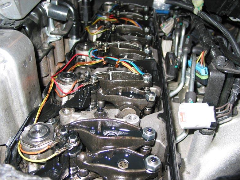 20 INSTALLING THE MODIFIED OEM SPACER GASKET / INJECTOR HARNESS Wipe any oil or residue from both sides of the valve cover gasket and inspect it for imperfections that could cause an oil leak.
