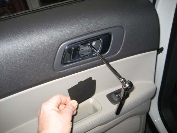 (10mm socket) Underneath door handle, remove plastic cover and bolt.