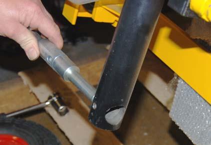 Tap the retaining pin out of its channel as shown in photo E.