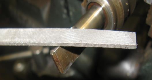 Drive the 3/16-inch roll pin from the drive gear noting the dimple to