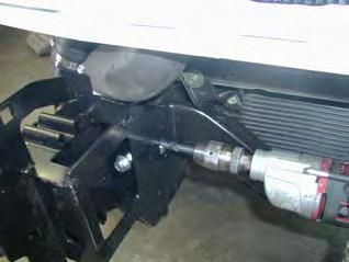 Using a 13mm drill bit, drill through chassis rails using hole in impact absorber as a