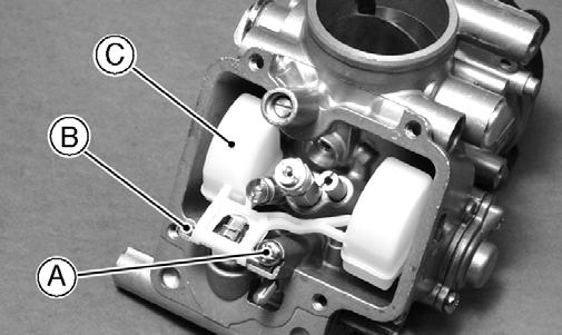 Drain all fuel from the carburetors; then remove the screws securing the float chamber and remove the float chamber.