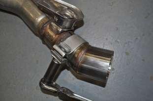 25. Tighten the muffler tie bracket hardware at this time using a 13mm wrench, along with a 13mm socket and 3/8 ratchet.