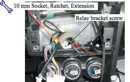 Loosen the screw holding the relay bracket in place, located behind the radio head unit (picture 22) 27.