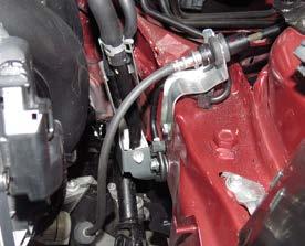 22. Disconnect the engine harness from the ECM by depressing the black clips and lifting up the grey levers