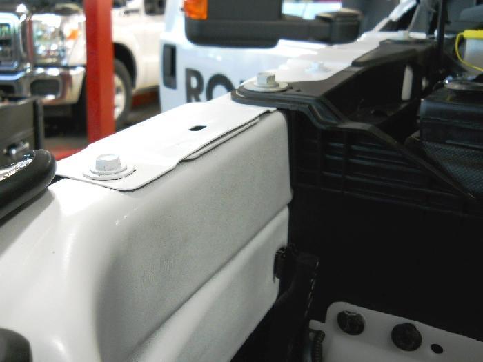 Tighten the upper front fender bolt to specification. Note: Leave the battery tray bolt out until after the underhood electrical harness has been installed.
