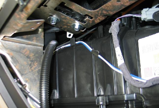 Note: If equipped, remove any sound deadening material from the location to drill. This material might cause improper seating of the harness grommet. Figure 13.1. 2.