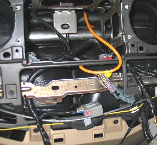 Lower the glove box out of the way. Figure 13.2. 4. Remove the upper instrument panel center finish panel screw covers (2). Figure 13.3. Remove the two panel screws. Figure 13.4. 5.