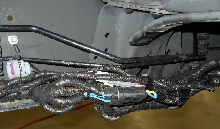 EFPR Location Originally Equipped with Mid-ship Gasoline Tank 12. Disconnect the OEM electrical connector from the OEM EFPR on the left frame rail.