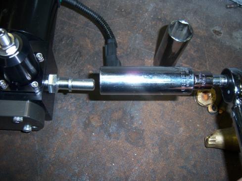 Install the 08J2044-3/4UNF fitting into the IN side of the fuel pump by, first, hand threading the fitting into