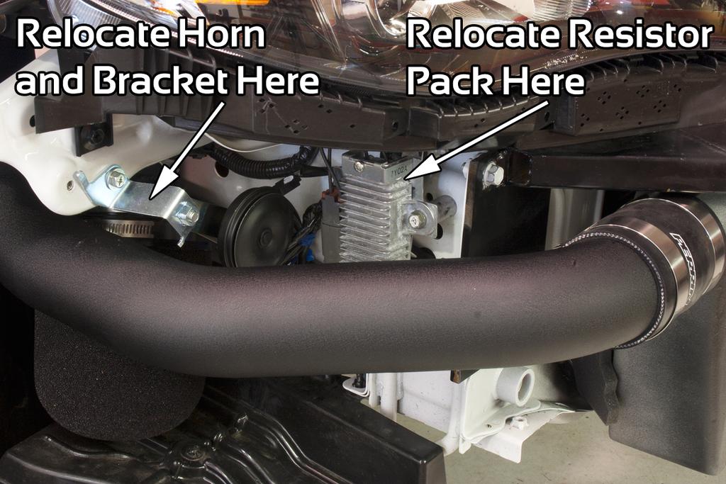 Where tube passes through fender area, make sure it passes through opening closest to front of car. Use 2.75 Size T- bolt clamps on both silicone couplers.