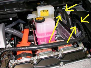 Locate the large vehicle harness grommet on the left side.