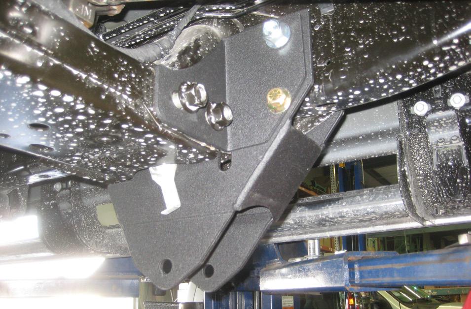 Go back to all the hardware installed for this bracket and using the (2) transmission crossmember bolts, the