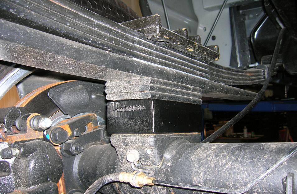 Position a pair of hydraulic floor jacks under the rear axle.