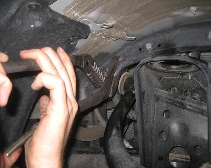 Special Note: On some vehicle models, the pinch weld of the fender can interfere with removing the bolt, if this