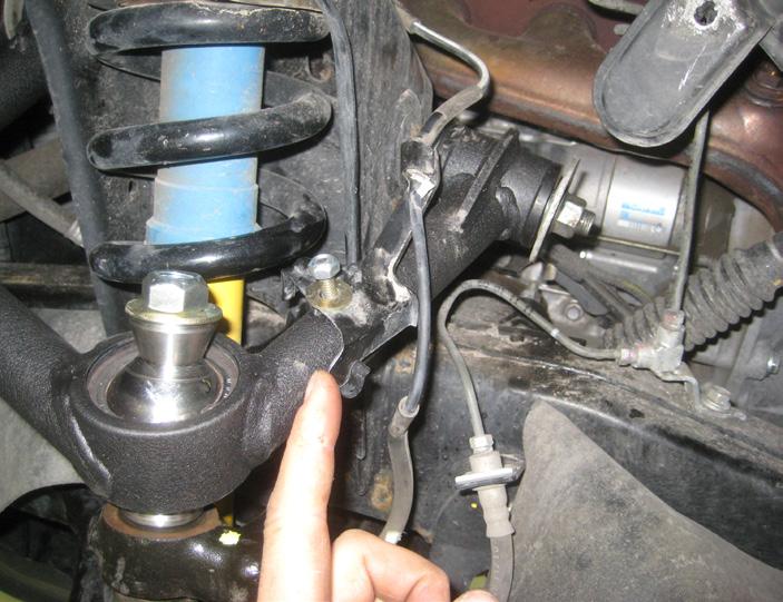 Locate the front differential mounting points, carefully remove the (2) OE bolts that connect the front differential brackets to the front crossmember, save