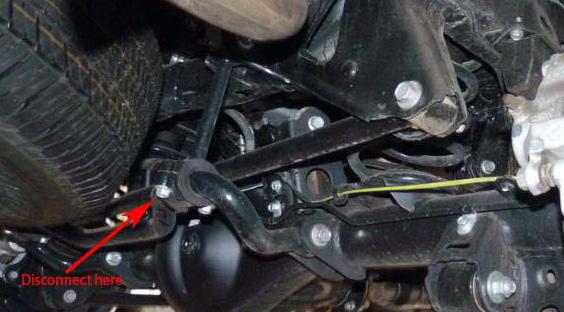 Remove the bolt holding the rear track bar to its upper mount on the passenger side. 31. Remove the emergency brake cable bracket from the lower control arm to gain slack. 32.