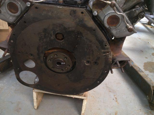 Engines sealed with a bolt have a backplate that incorporates a cutout for