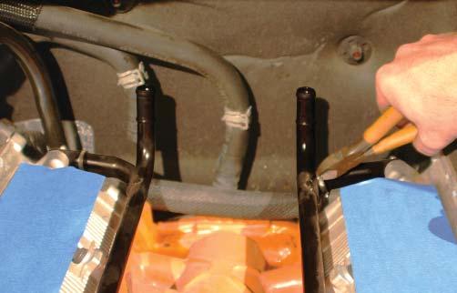 There are two zip-tie clamps holding the wire harness to the heater hard line mounting