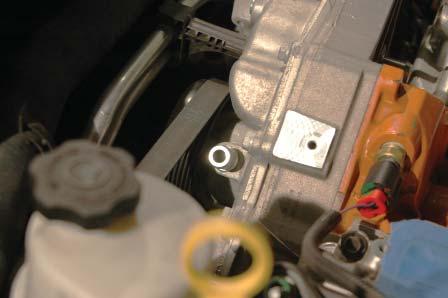 48. Use your fi ngers to press the other prepared barb into the driver side hole of the water pump that was