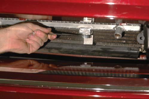 Use a flathead screwdriver to carefully lever the tabs free from their locking position.