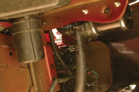 140. Connect the short end of the hose to the inlet barb of the intercooler pump using one of
