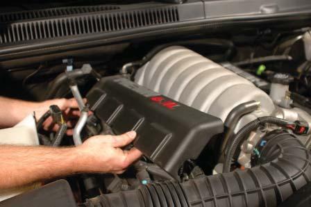16. Remove the two HEMI coil covers from the vehicle by pulling up to