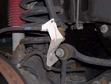 3. Remove bolt and brake line bracket from lower spring perch. 6.