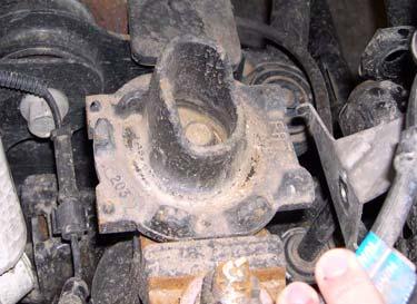 8. Remove bolt and lower spring perch from